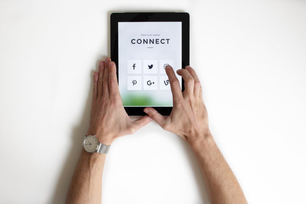 iPad that has social media graphics and the word,