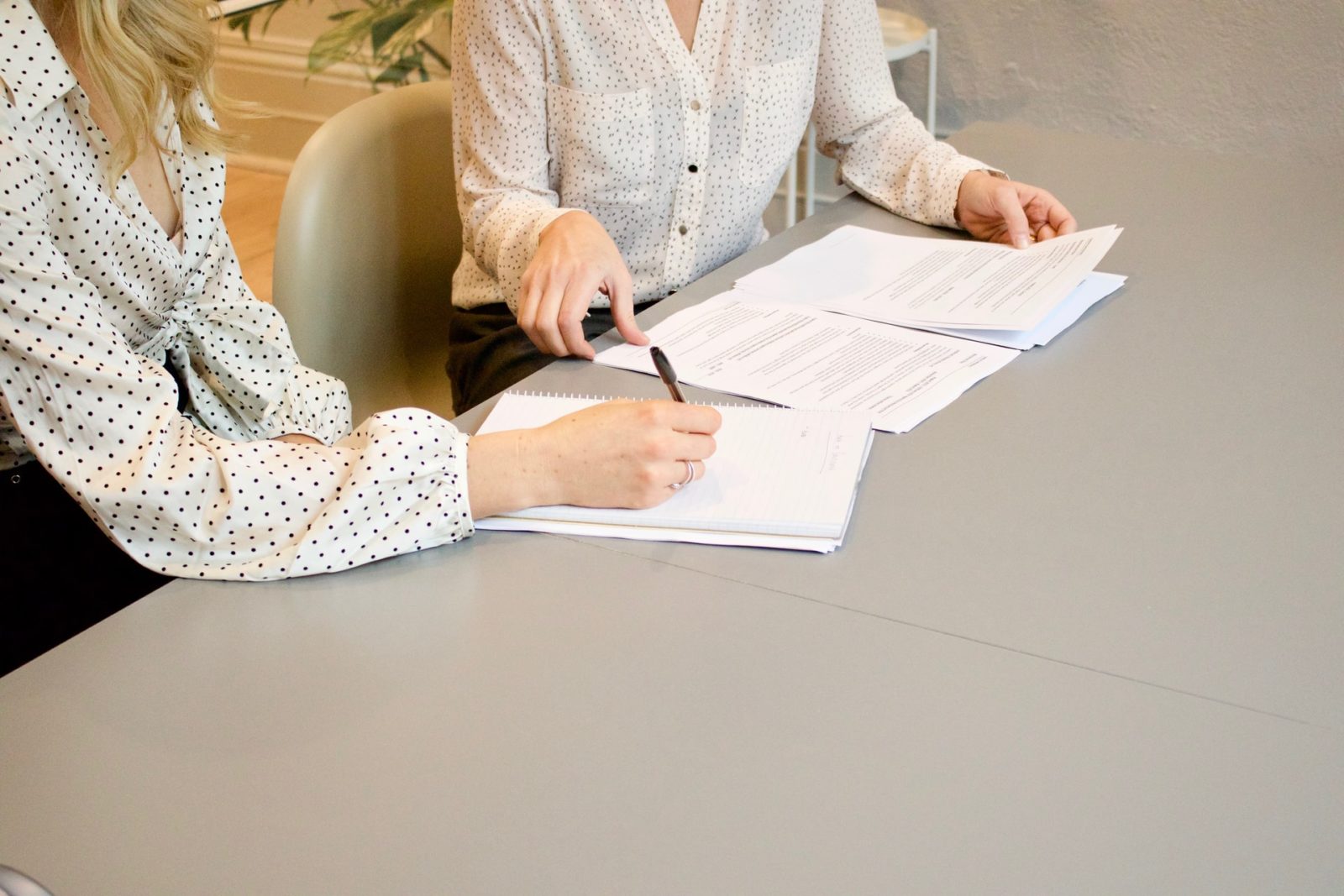 hands signing contracts