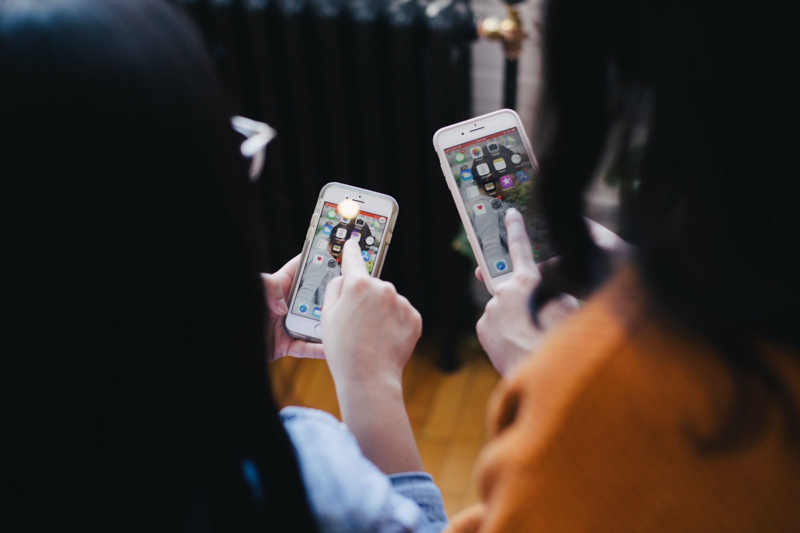 two people on their phones looking at social media