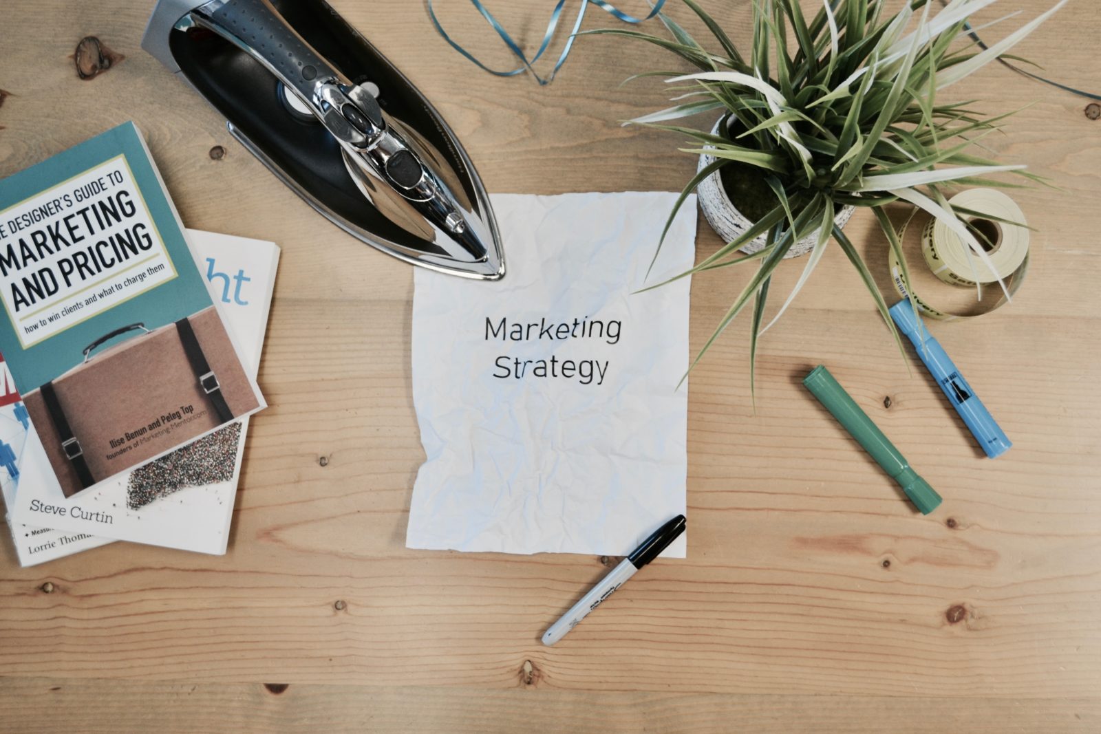 Desk with a paper that says Marketing Strategy on it