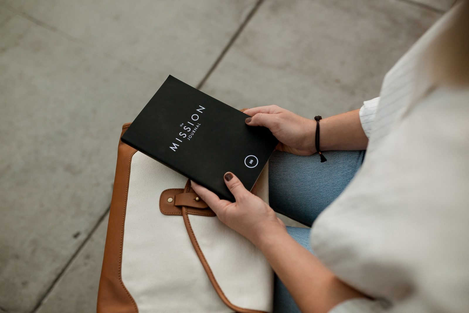 woman holding a journal that says mission