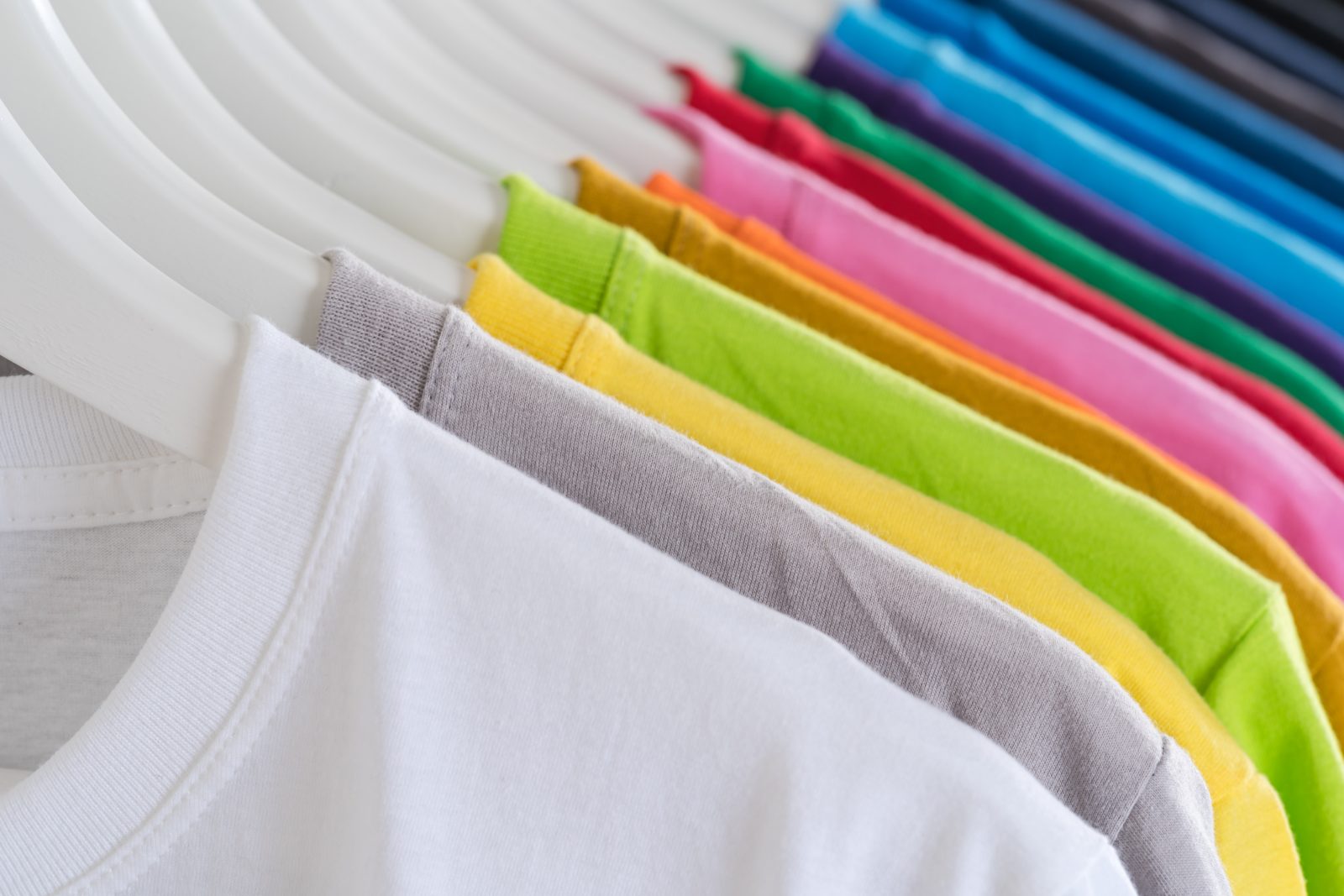 multi-color t-shirts on a hanger