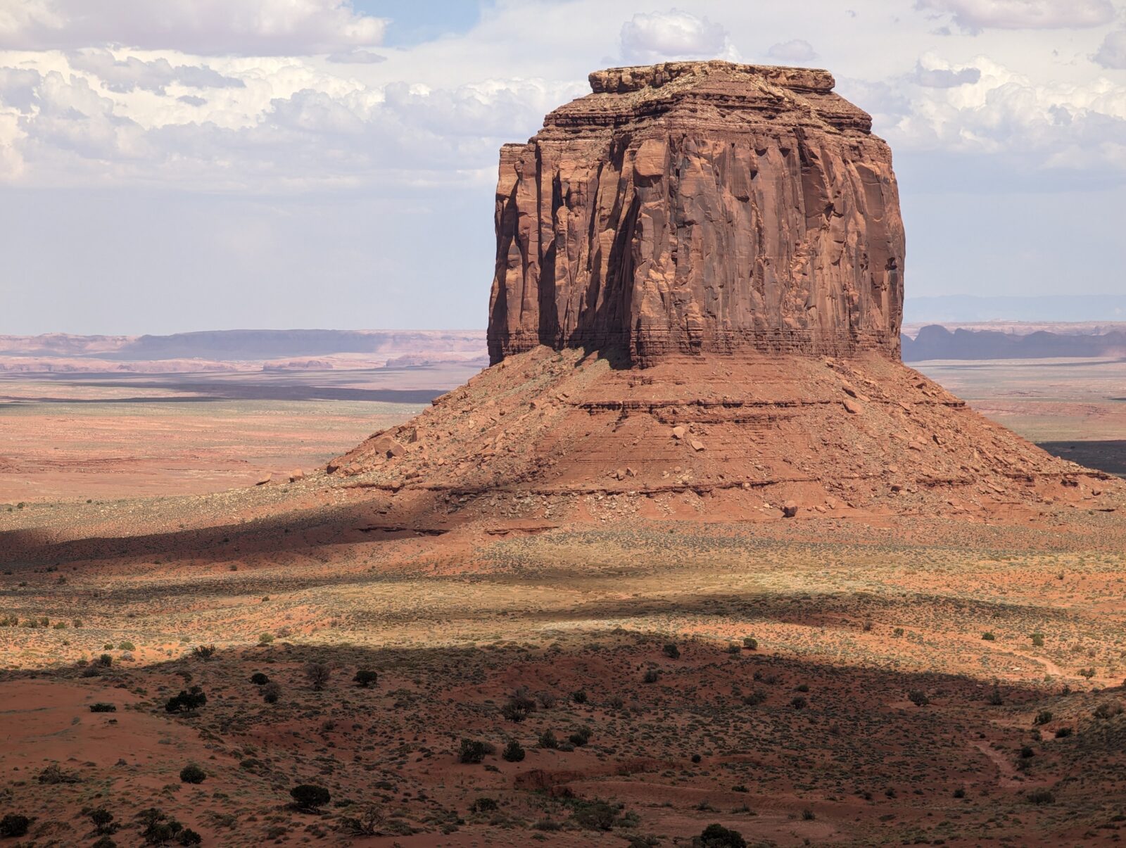 A massive rock formation standing tall, showcasing nature's grandeur and rugged beauty.